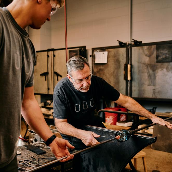 Artist making glass at Glasshaus