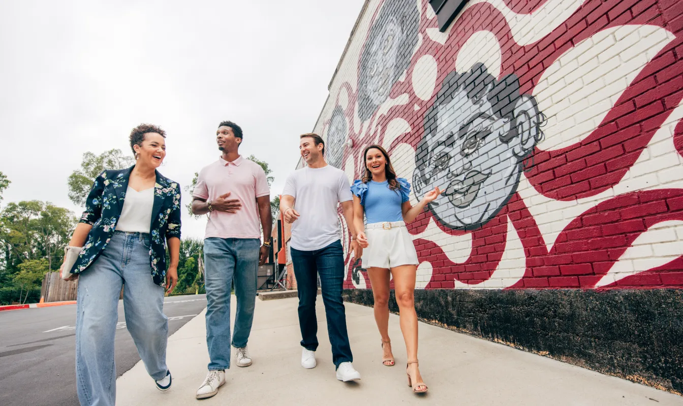 Friends walking by mural in North Nashville