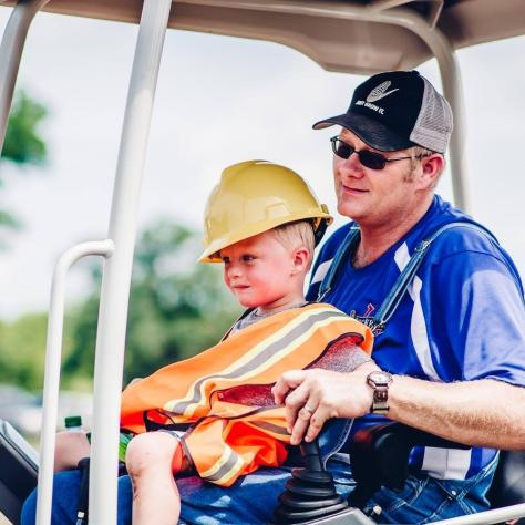 Family driving construction truck at Lucky Ladd Farms