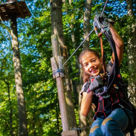 Girl ziplining at Treetop Adventure Park at Nashville Shores