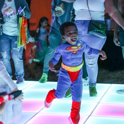 Young boy dressed as Superman at Boo at the Zoo