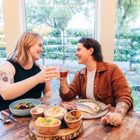 Couple toasting at Dinner at Husk