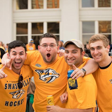 Guys cheering for the Nashville Predators
