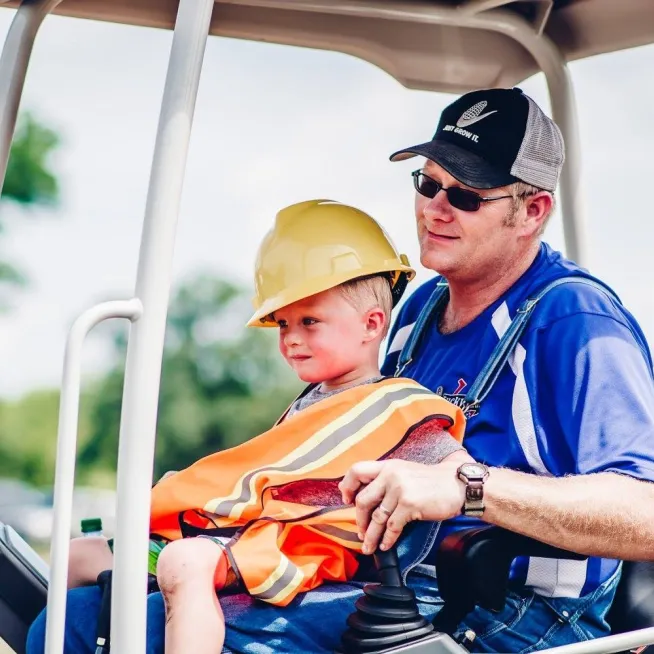 Family driving construction truck at Lucky Ladd Farms