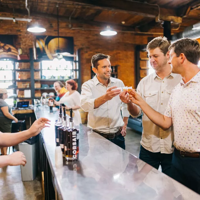 Guys toasting at Cosair Distillery 