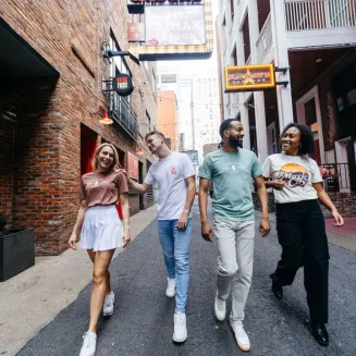 Group of friends walking on a Nashville street near live music venues