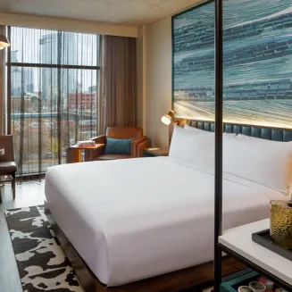 Settle into your fresh, bright upper-floor room, furnished with one king bed and a separate living space with its own work table and comfy seating area—a welcoming, efficient hotel room for relaxing and entertaining.