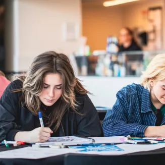 Two young women drawing