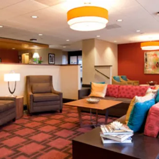 Hotel lobby with colorful seating area and modern lighting.