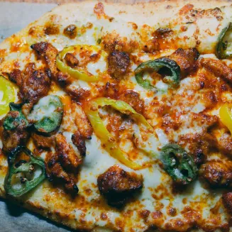 Ranch Sauce, House Cheese Blend, Hot Smoked Chicken and Chicken Sausage, Fresh Jalapenos, Banana Peppers and Hot Honey Drizzle