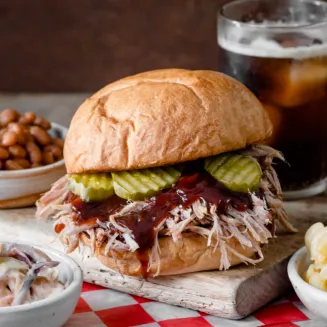 Catered Meal offering a Pulled Pork Sandwich, Mesquite Coleslaw, Baked Beans and Mac & Cheese.