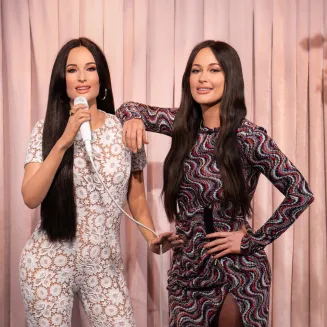 Known for her unique blend of country, pop, and folk music, singer-songwriter Kacey Musgraves poses alongside her one-of-a-kind wax figure.