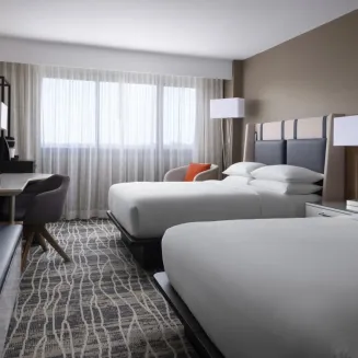 Newly renovated guest room with two queen beds, coffee maker, mini-refrigerator, in-room safe and complimentary standard wifi.