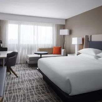 Standard King Guest room with chaise lounge, coffee maker, mini-refrigerator, in-room safe and complimentary standard wifi.