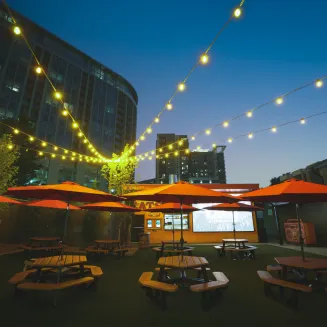 Experience Odie's expansive outdoor patio with dynamic group seating, two bars, an outdoor kitchen & massive LED screen perfect for gamedays!