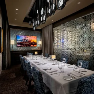 The Speakeasy is a fully private room, located on the second floor of the restaurant (adjacent to the main dining room) and can accommodate up to sixteen guests in total.  Complimentary audio-visual (86" flat screen TV with HDMI cable) is provided, with windows overlooking Broadway, and is reservable with a food and beverage minimum requirement.  The Speakeasy is set conference style (one table down the center of the room), and is just one of our five private dining rooms.