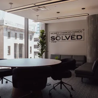 The Money Lab room at The Greatness Factory of Nashville is a modern flex space designed for intentional connection and high-value conversations. Overlooking vibrant 5th Avenue, it features sleek lighting and a smart TV with whiteboard capabilities—perfect for brainstorming, strategizing, and presenting ideas. Ideal for powerful masterminds, meaningful discussions, and sparking profitable breakthroughs in a relaxed yet focused setting.