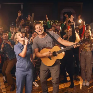 A group of singer-songwriters performing at Song House