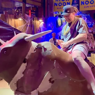Bar crawl guest riding the mechanical bull!