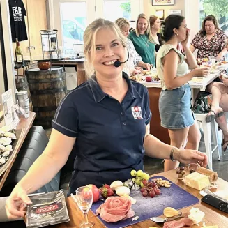 Lynn instructing a Cheese and Charcuterie Board Building Class