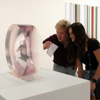 Couple looking at a round glass sculpture