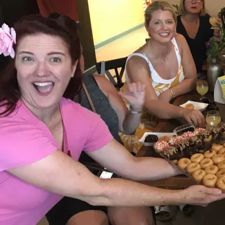 Tour guide Red and guests sampling food on driving tour