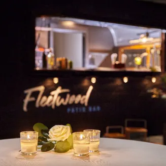 Fleetwood Patio Bar trailer with candles and flower on a table in the foreground.