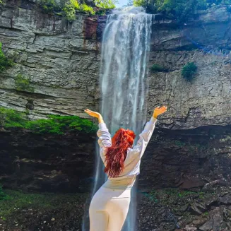 Woman with red hair standing at Fall Creek Falls