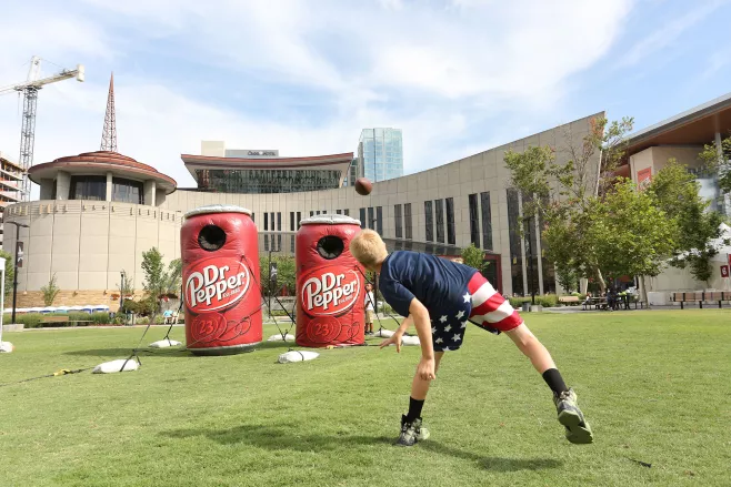 Kid tossing football at Amazon Family Fun Zone