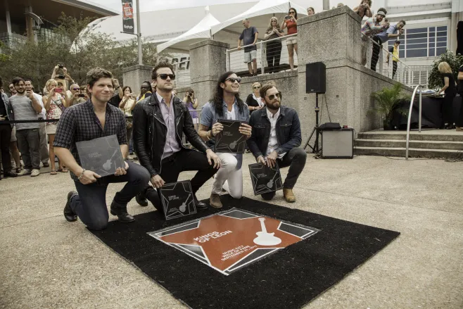 Kings of Leon with their star at the Music City Walk of Fame.