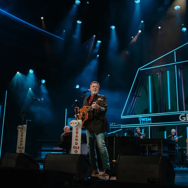 Vince Gill performing on stage at the Grand Ole Opry.