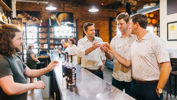 Guys toasting at Cosair Distillery 